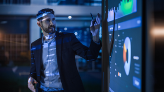 Man using a projector on a screen in an office